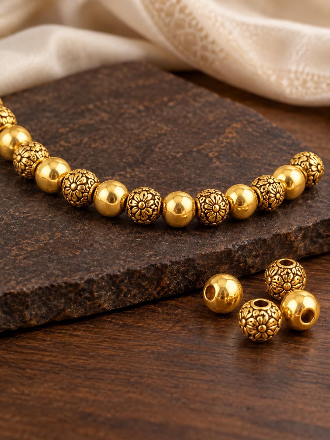 Gold-tone metal beads, plain and floral-engraved