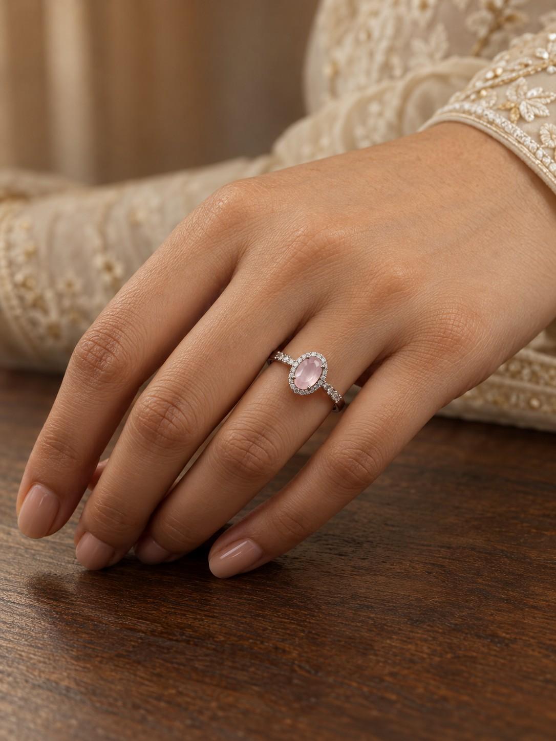 Silver-look women's ring with a soft pink stone and halo